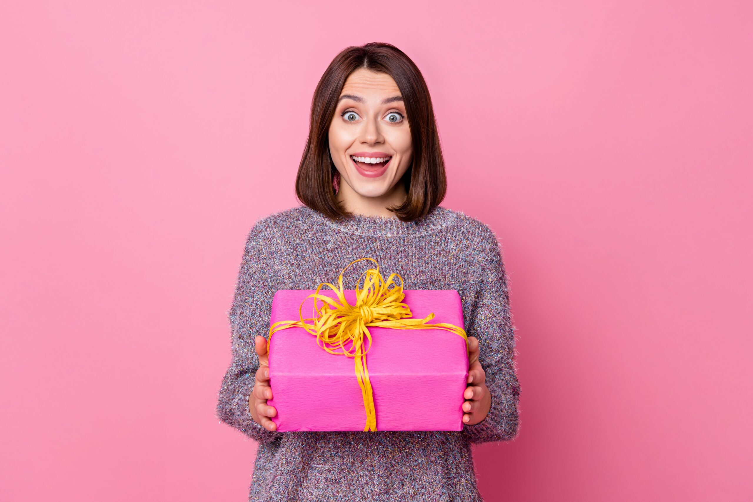 Woman holding a pink gift box for a loved one with anxiety