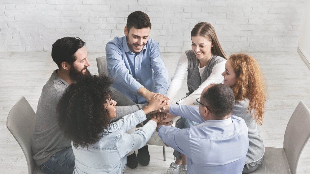 Smiling people in addiction group therapy