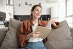 Woman reading a notebook with quotes on addiction recovery sobriety