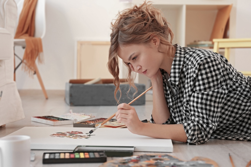 Female managing boredom in recovery by painting